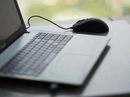 notebook with mouse on the table photo