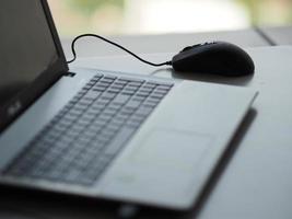 notebook with mouse on the table photo