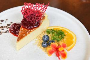 Cheese cake slice with raspberry sauce on withe plate - cheesecake fruit delicious dessert photo