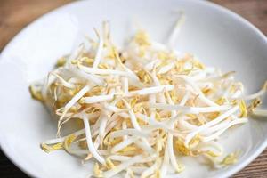 Bean sprouts on white plate table background in the kitchen, Raw white organic bean sprouts or mung bean sprout for food vegan photo