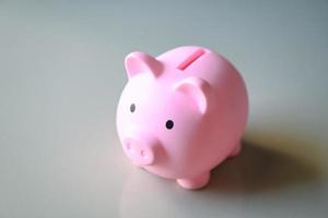 Piggy bank on floor background, pink piggy bank saving money for education study or investment concept photo