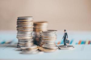stacked coins financial and business man on business graph paper analysis of business investment concept money photo
