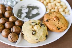Set of macadamia nut packaging on tray plate natural high protein - cookies chocolate with macadamia nuts photo