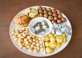 Set of macadamia nut packaging on tray plate natural high protein - cookies chocolate with macadamia nuts photo