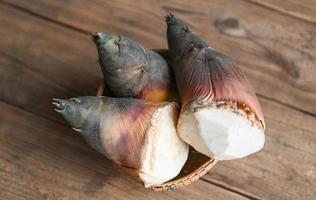 Fresh raw bamboo shoot for cooking food in thailand, Bamboo shoots on wooden table background photo