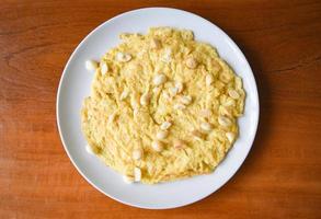 Omelette breakfast with macadamia nuts on top on white plate Healthy food photo