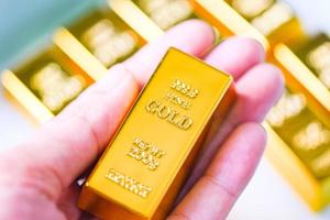 Gold bars in hand, Stack of gold bars financial business economy concepts, wealth and reserve success in business and finance photo