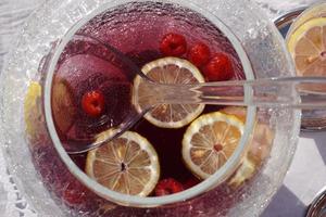 A Glass Bowl With Citrus Fruit Slice And Berrys And A Ladle On The White Table. photo