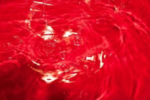 Red abstract chaotic backgroud with seamless pattern. Red liquid surface texture. photo