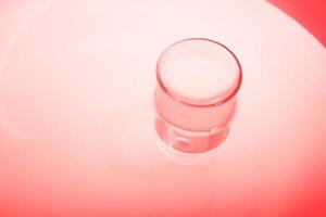 Abstract red shiny surface with a round object. Water in water. Abstract red background. photo