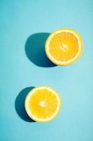 Two pieces of fresh orange on blue background. photo