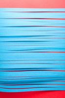 Blue cit paper strips background. Simple color paper background in blue and red. photo