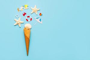 Ice cream cone with sea shells,starfish and beach drawings with space for text. Summer holiday concept photo