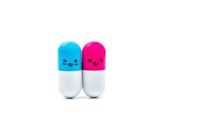 Cute blue and pink couple capsule pills isolated on white background with copy space for text. Global healthcare concept. Taking care of couple life photo