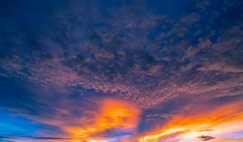 Beautiful sunset sky. Golden and orange sky and clouds with sunbeam. God light concept. Nature background. Power in nature. Tranquil and inspiration abstract background. Beautiful sun rays. photo