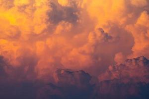 Yellow, orange fluffy clouds on sunset sky background. Art picture of orange clouds texture. Beautiful pattern of clouds. Freedom and calm background. Beauty in nature. Powerful and spiritual scene. photo