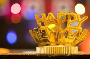 Golden Happy New Year headband on colorful bokeh background photo