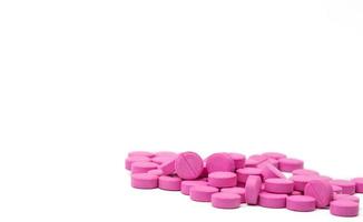 Pile of warfarin pink tablet pills on white background. Warfarin for treatment deep vein thrombosis. Anticoagulant medicine. Pharmacy drug store product. Pharmaceutical industry. Anticoagulation. photo
