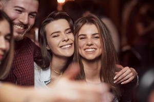 Feeling happy. Beautiful youth have party together in the nightclub photo