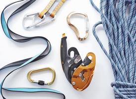 Store shelf. Top view. Climbing equipment for the safeness lying on the white table. Conception of extreme sports photo