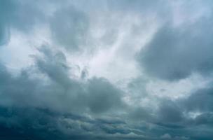 Dark dramatic sky and clouds. Background for death and sad concept. Gray sky and fluffy white clouds. Thunder and storm sky. Sad and moody sky. Nature background. Dead abstract background. Cloudscape. photo