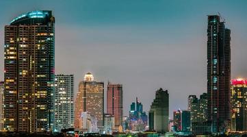 Cityscape of modern building in the night. Modern architecture office building. Skyscraper with beautiful evening sky. Business and financial center building. Condo in the city with night light. photo