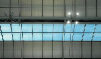 Roof and glass skylights of the airport. Interior architecture design. Skylights with lamp light. Modern building roof structure. Saving energy and eco friendly building. LED lamp light on ceiling. photo