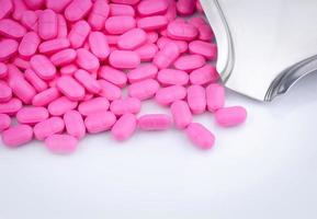 Top view of pink tablets pills on stainless steel drug tray. Pharmaceutical industry. Pharmacy drugstore products. Drug count. Medication use in hospital. Pharmacology. Prescription drugs. Healthcare. photo