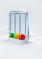 Device for exercising respiration through deep inspiration triple chamber. Medical equipment for respiratory therapy after surgery. Deep Breathing lung exerciser. Breath Measurement. 3 color balls. photo