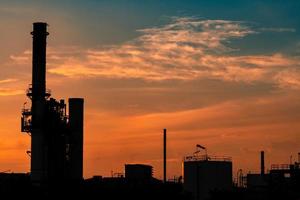 Gas turbine electrical power plant. Energy for support factory in industrial estate. Natural gas tank. Small gas power plant. Power plant using natural gas for fuel. Green energy. Dramatic sunset sky. photo