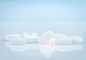 Pile of white oblong tablets pills on gradient background. White antibiotic tablet pills. Pharmaceutical industry. Pharmacy product. Drug in pharmacy drugstore or hospital. Antibiotic drug resistance. photo