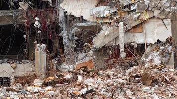 Destroyed building industrial. Building demolition by explosion. Abandoned concrete building with rubble and scrap. Earthquake ruin. Damaged or collapsed building from hurricane disaster. photo