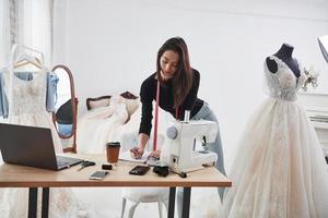 Modern room. Female fashion designer works on the new clothes in the workshop photo
