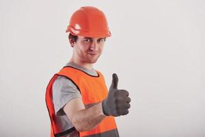 No troubles, I'll make everything perfect. Man in orange colored uniform stands against white background in the studio photo