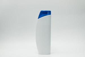 Shampoo or conditioner bottle with blue dispenser pump isolated on white background with blank label and  copy space. Use for advertise shampoo or conditioner. Cosmetic product package. Beauty product photo