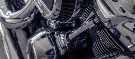 Selective focus on a motorcycle engine. Shiny chrome motorbike engine detail. Vintage motorbike. Closeup motorcycle air filter. Motorcycle industry. photo