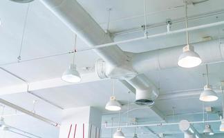 Air duct, automatic fire sprinkler safety system. Fire protection and detector. Fire sprinkler system. Building interior concept. Ceiling lamp light with opened light. Interior architecture concept. photo