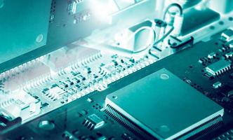 Electronic circuit board. Mainboard of computer. Computer integrated circuit board. Detail of electronic circuit board. Memory of digital information hardware. Electronic engineering technology. photo