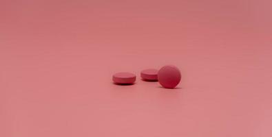 Selective focus on round pink tablet pill on pink background. Pharmacy horizontal web banner. Pharmaceutical industry. Prescription drug. World Health Day background. Vitamins and minerals concept. photo