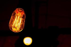 Macro photo of light bulb illuminated. Closeup view of individually illuminated filaments.