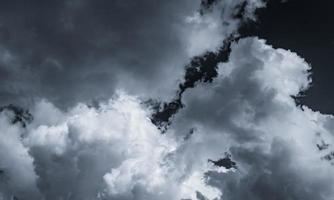 Dark dramatic sky and clouds. Background for death and sad concept. Gray sky and fluffy white clouds. Thunder and storm sky. Sad and moody sky. Nature background. Dead abstract background. Cloudscape. photo