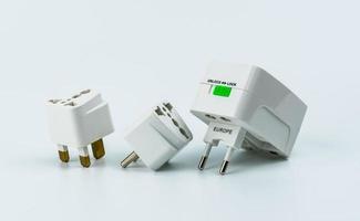 Set of universal plug adapters for travel around the world isolated on white background. photo