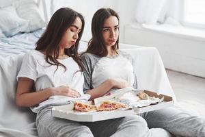 I don't expected that this will go that way. Twins have full stomach with pizza. Nice bedroom at daytime photo