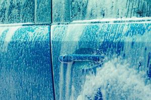 Background - Going through an automatic car wash - soapy water blowing up  window with dark blur outside.j Stock Photo