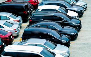 Car parked at parking lot of the airport for rental. Aerial view of car parking lot of the airport. Used luxury car for sale and rental service. Automobile parking space. Car dealership concept. photo