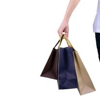 Woman carrying paper shopping bags isolated on white background. Adult woman hand hold three shopping bag with blue and brown color. Customer and shopping bag. Woman buy gift for friends or husband. photo