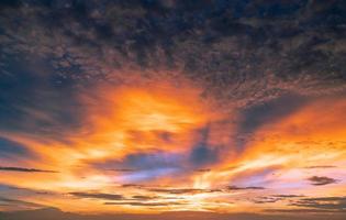Beautiful sunset sky. Golden and orange sky and clouds with sunbeam. God light concept. Nature background. Power in nature. Tranquil and inspiration abstract background. Beautiful sun rays. photo