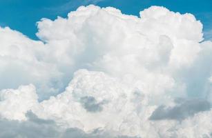 White fluffy clouds on blue sky. Soft touch feeling like cotton. White puffy clouds cape with space for text. Beauty in nature. Close-up white cumulus clouds texture background. Sky on sunny day. photo