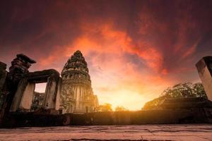 Selective focus on Phimai Historical Park with sunset sky. Landmark of Nakhon Ratchasima, Thailand. Travel destinations. Historic site is ancient. Ancient building. Khmer temple classical architecture photo