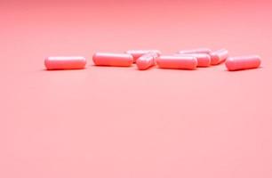 Pink capsule pills on pink background. Valentine's day concept. Pills of love. Treatment and care for love. Happy Valentine's day. Pharmacy background. Pharmaceutical industry. Health and medicine. photo